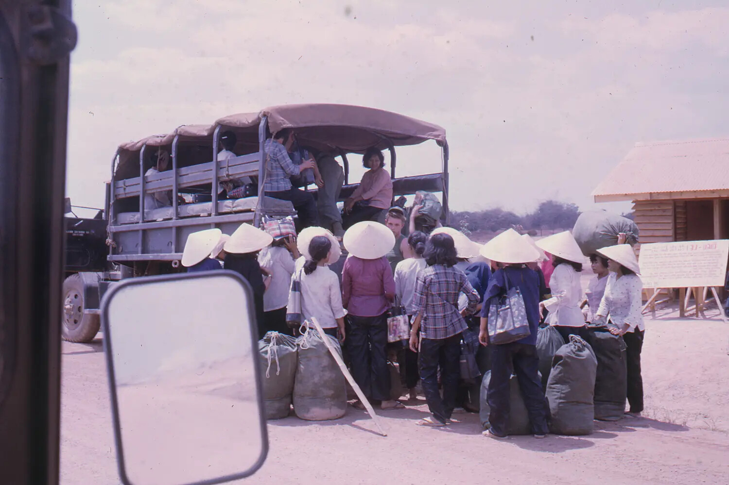 Vietnamese Civilians Boarding U.S. Military Truck During Tet Offensive Evacuation, 1968