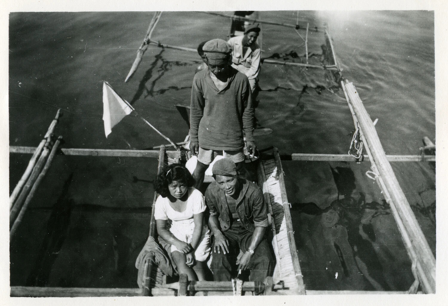 Filipino Family in Outrigger Banca Alongside U.S. Navy Vessel, WWII Pacific