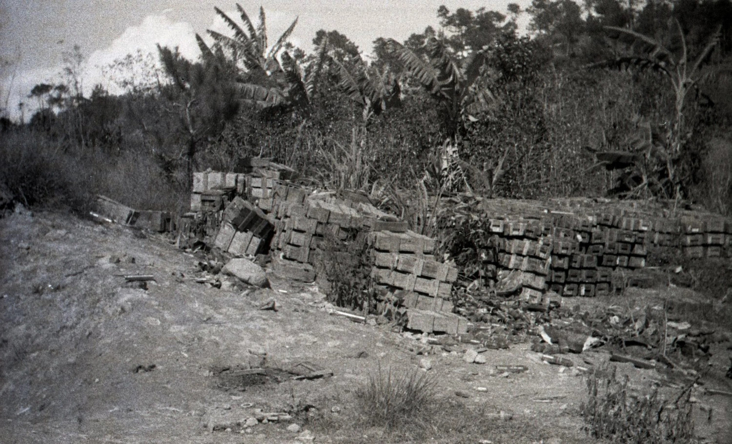 Stacked Wooden Ammunition Crates Along Roadside Embankment, Luzon, Philippines, World War II