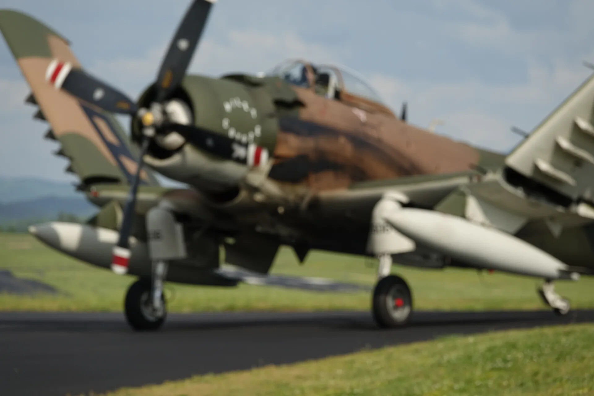 Douglas A-1 Skyraider Taxiing, Front-Quarter View with Red/White Tail Stripe Marking