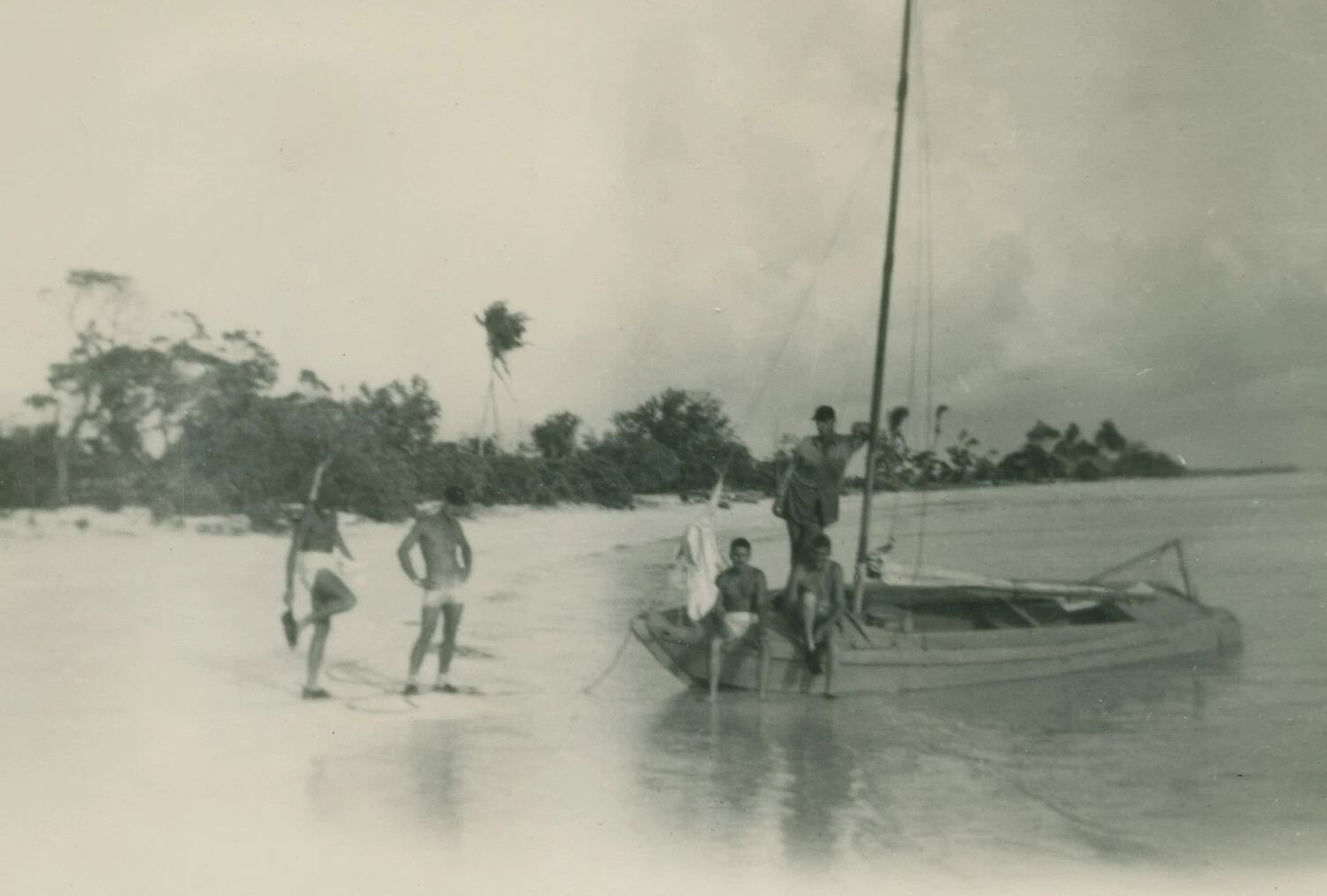 Servicemen and Local Outrigger Boat on Tropical Beach - McAleer Family Album