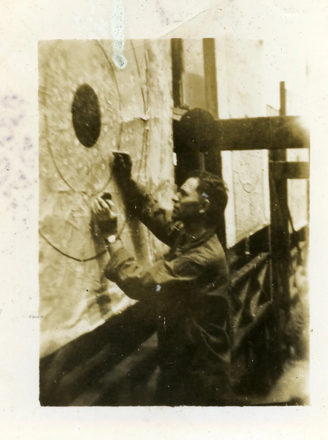 Serviceman Inspecting Circular Marked Surface Aboard Ship, World War II Era