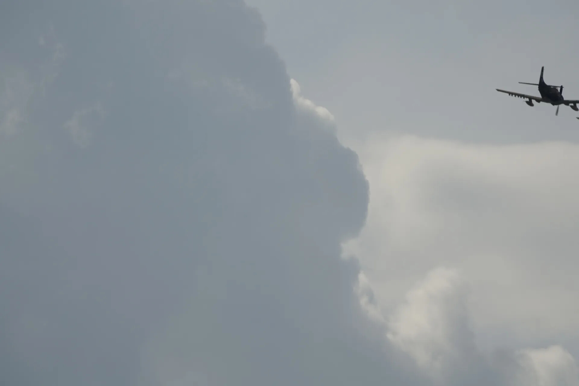 Propeller Warbird Silhouetted Against Storm Clouds