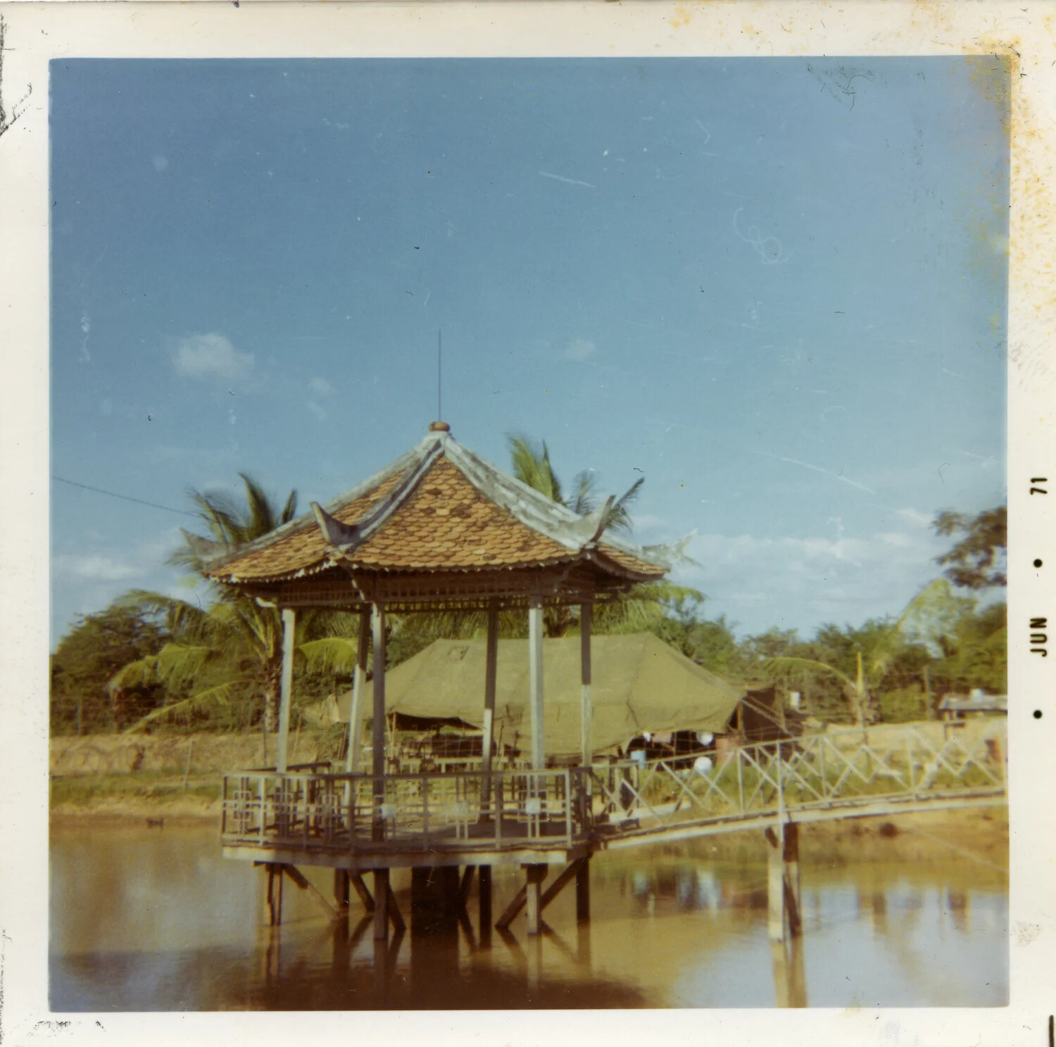 Vietnamese Pavilion and Military Tent Encampment Along a Delta Waterway, June 1971
