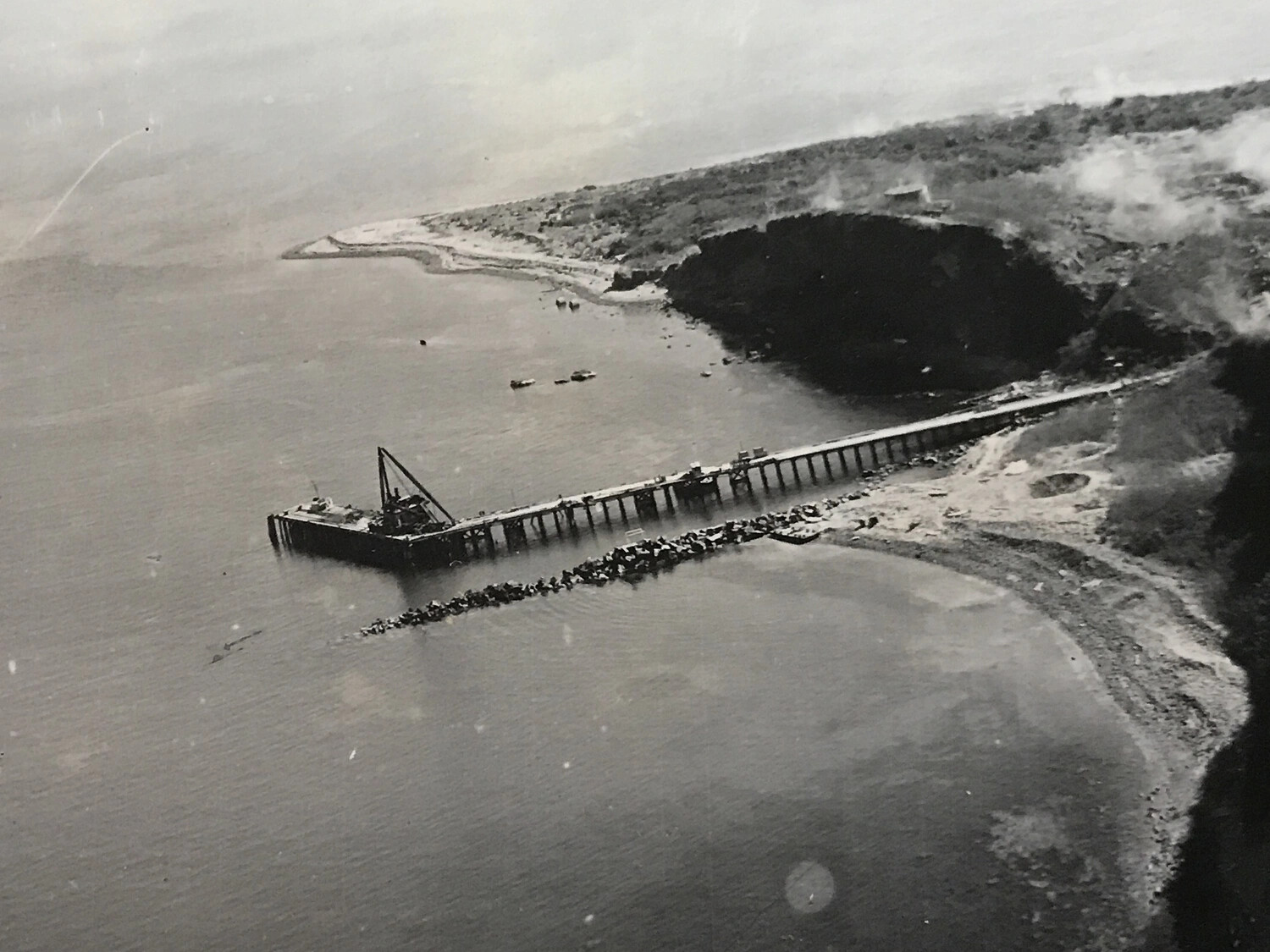 Aerial Photograph of Pier Construction/Repair with Floating Crane, Coastal Bay, Pacific Theater