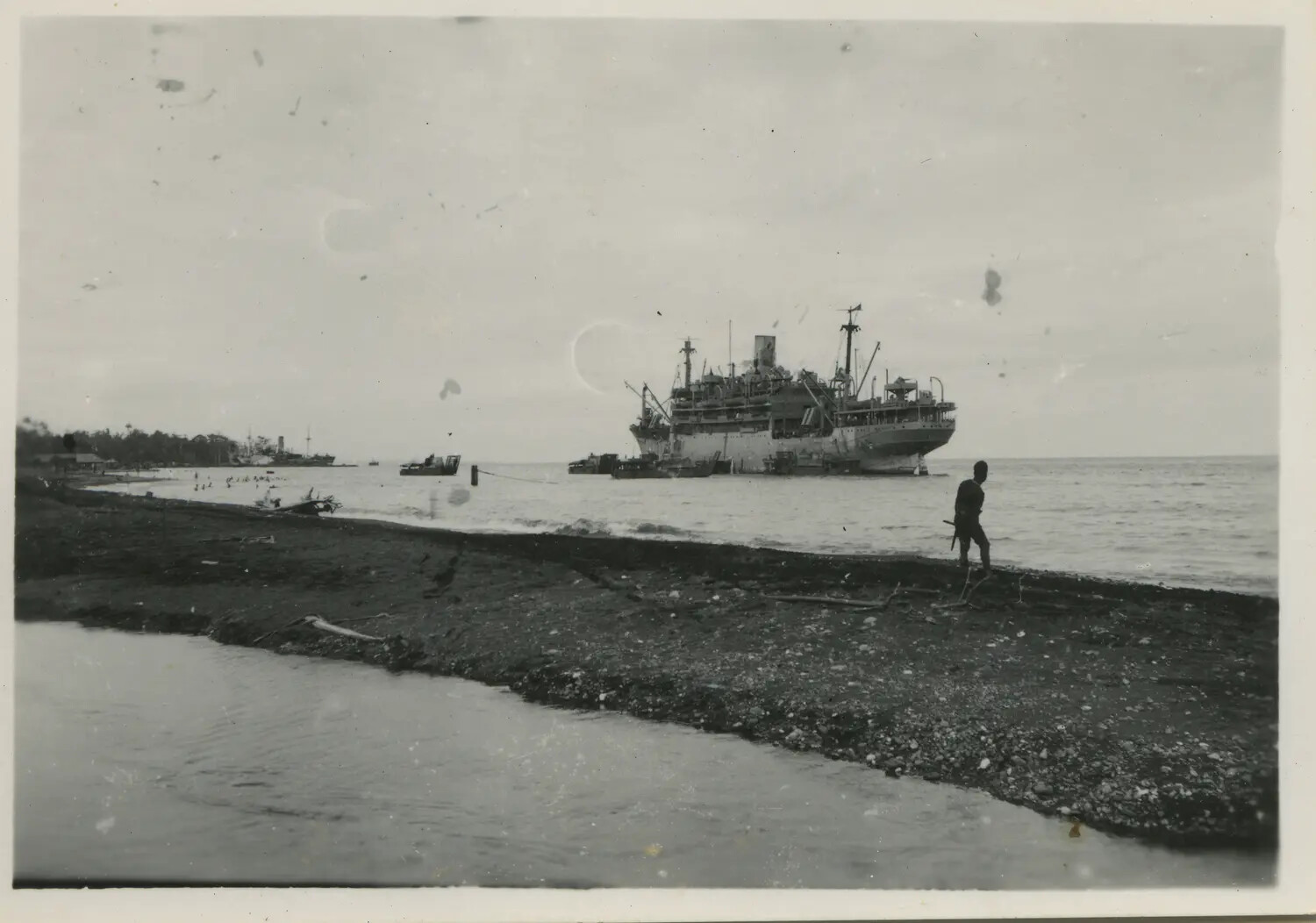 Supply Ship and Landing Craft Off a Pacific Beachhead, 312th Bombardment Group Support Area, WWII