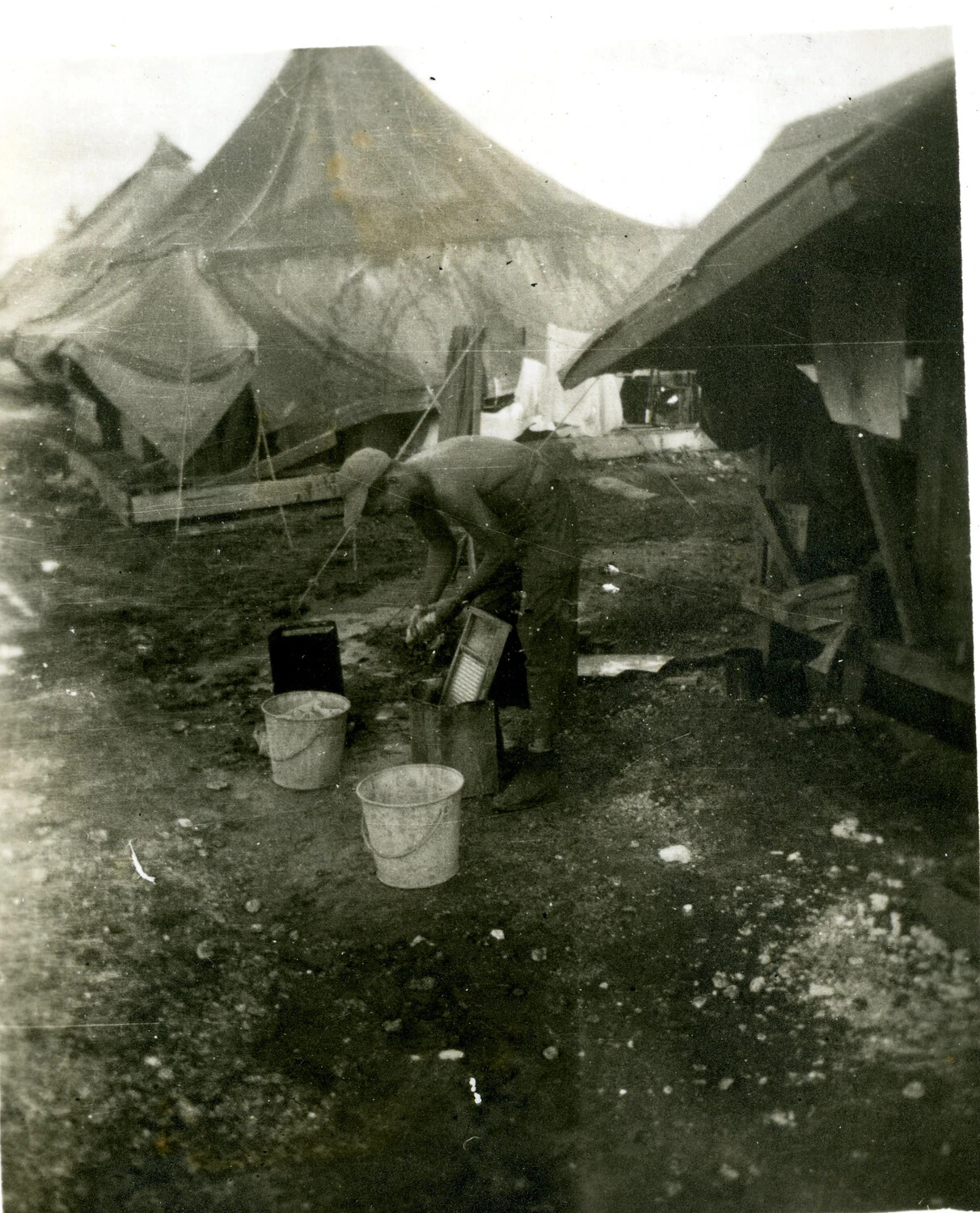 Serviceman Washing Laundry on a Washboard, 345th Bomb Group Encampment, Ie Shima, WWII