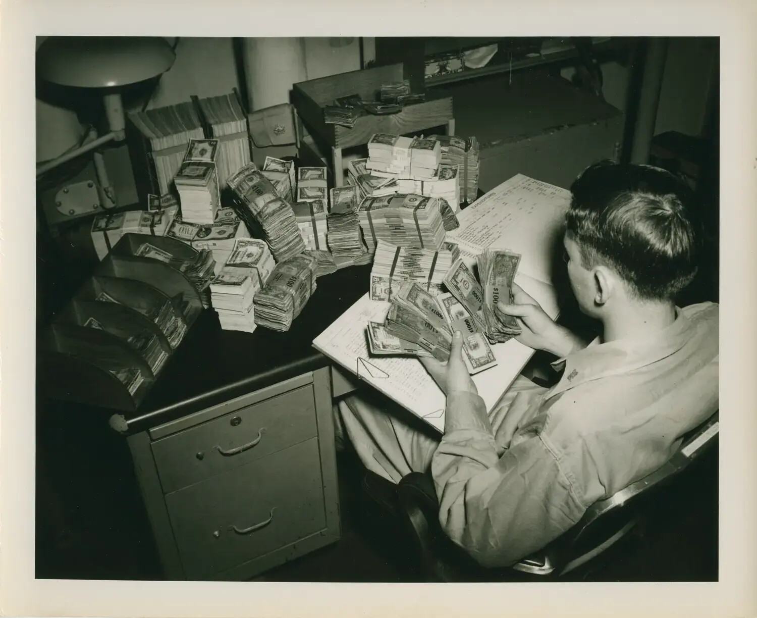 Ship's Disbursing Clerk Counting Currency, USS Petrof Bay (CVE-80)