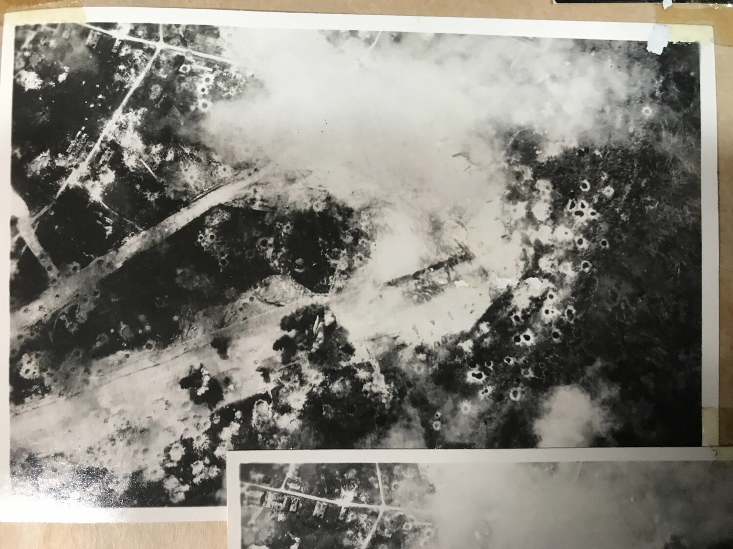 Vertical Aerial Photograph of Cratered Road Junction Amid Drifting Smoke