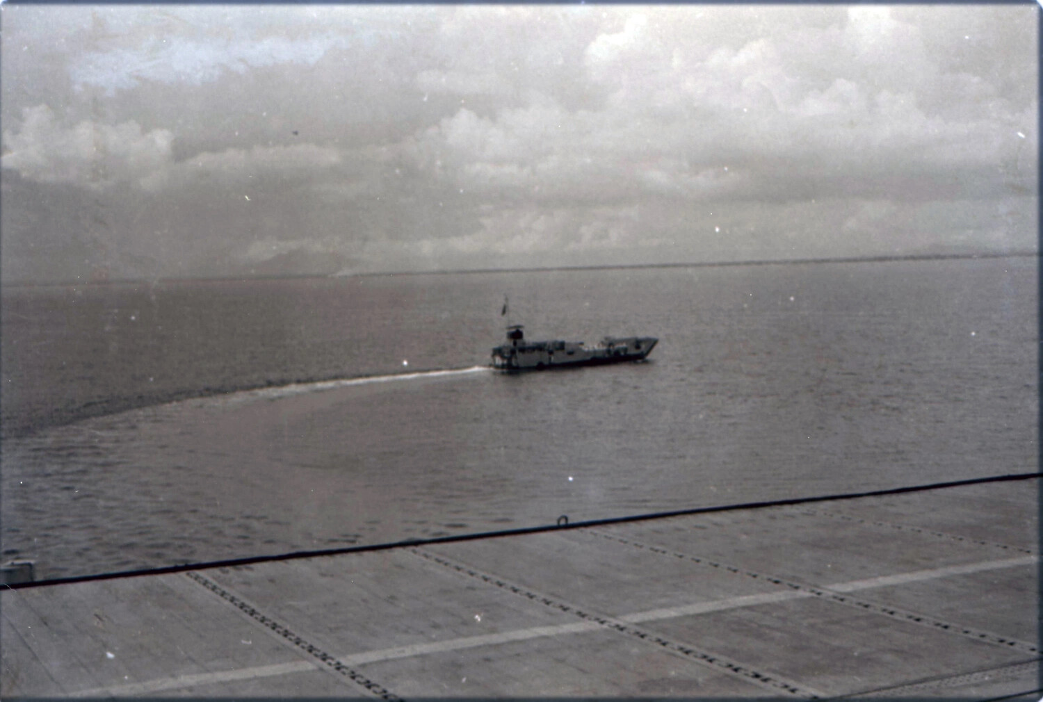 Small Craft Approaching USS Yorktown (CV-10) Near Coastline, 1953