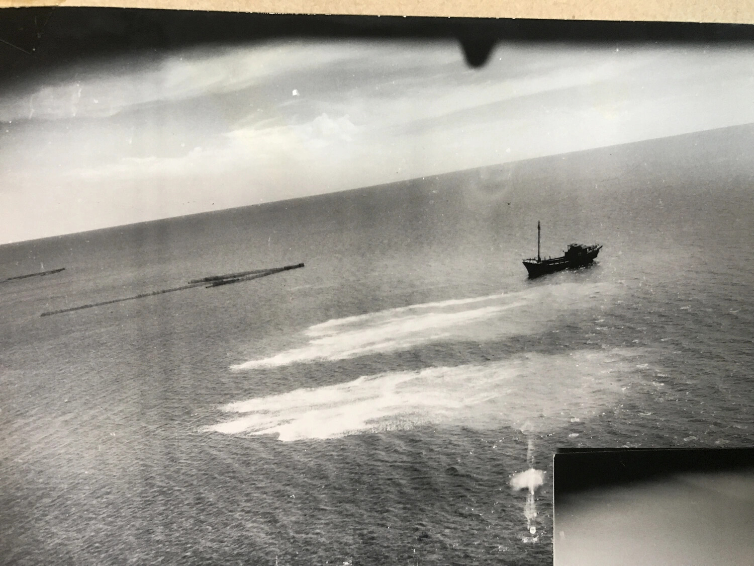 Full-Frame Aerial Attack Photograph: Small Vessel Under Strafing Fire at Sea, Pacific Theater, WWII