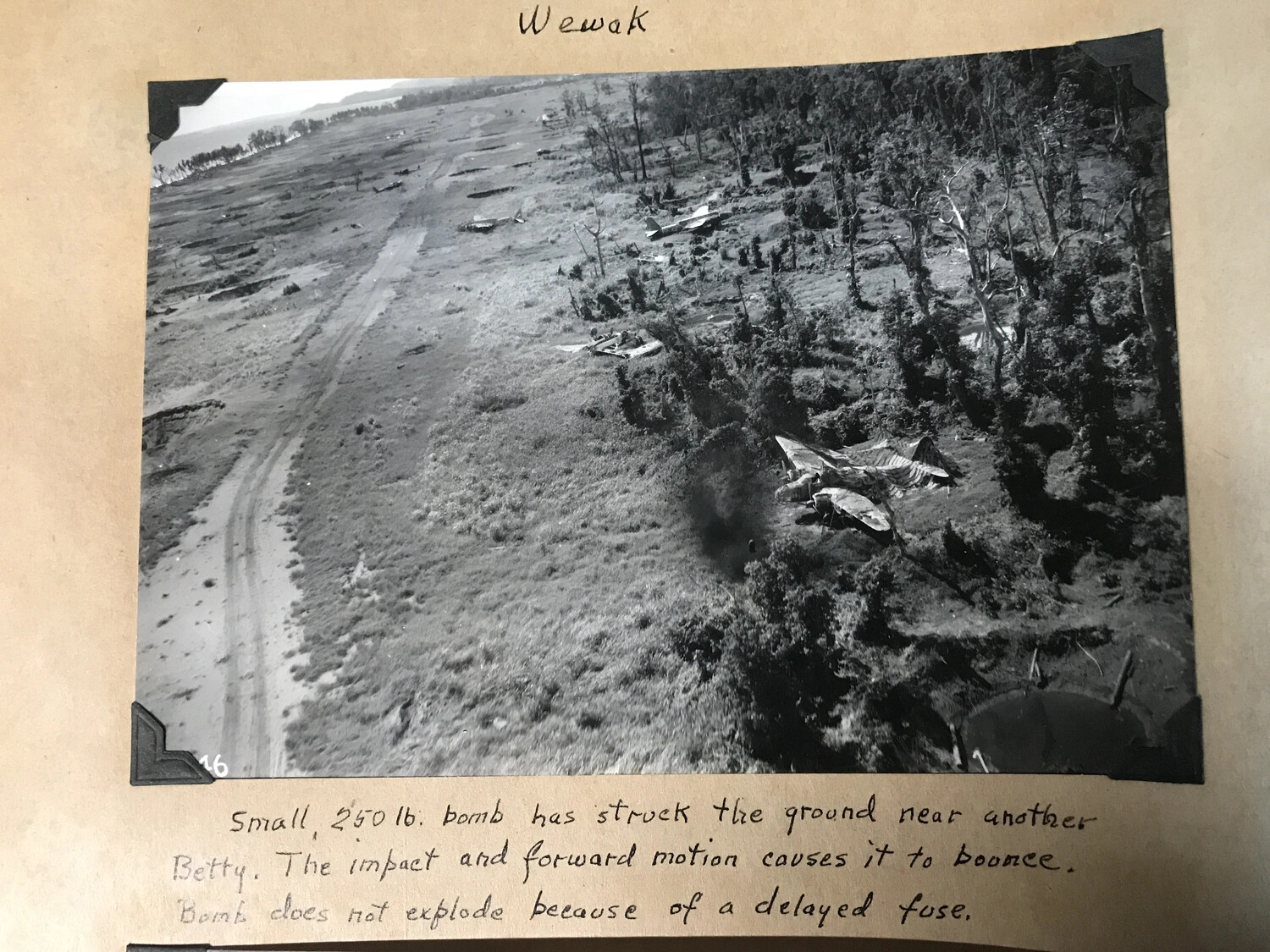 Wewak — Annotated Album Photograph of Bomb Impact Near Wrecked Betty Bomber