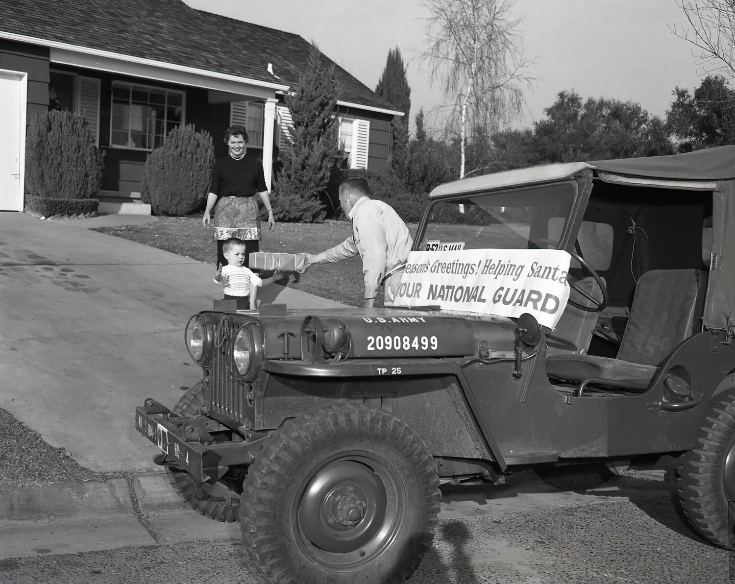 National Guard Jeep Delivers Christmas Gift to Child, 'Helping Santa' Community Outreach Program, c. 1958-1962