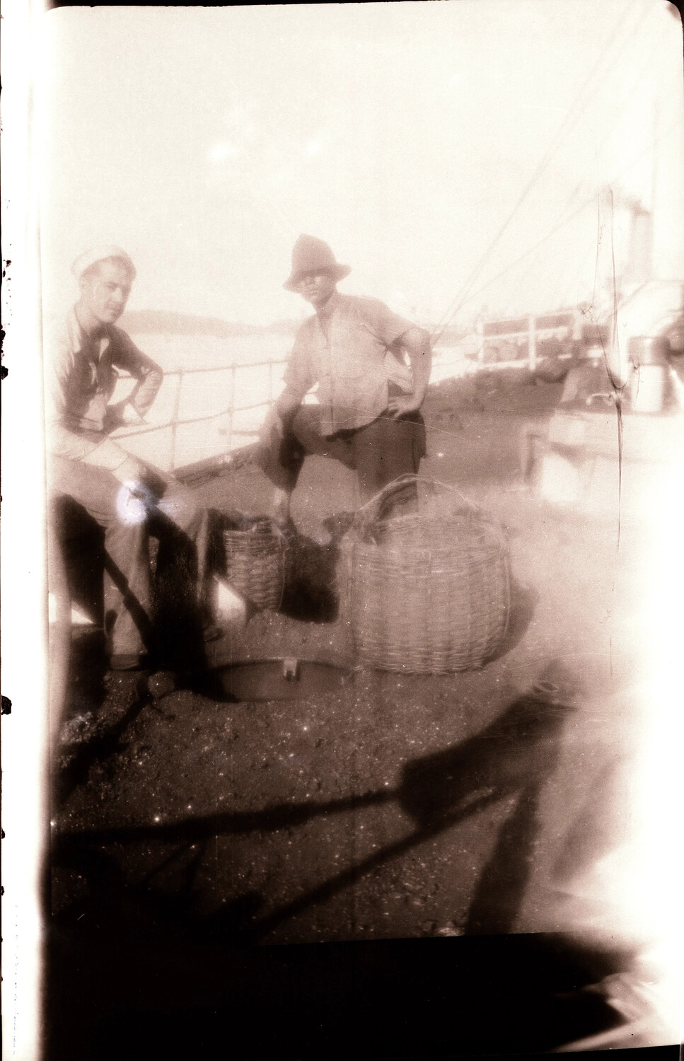 U.S. Sailor and Local Boatman Aboard Harbor Craft, China Station, 1930s (Overexposed Print)
