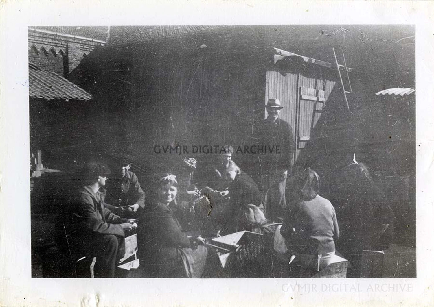 Villagers and Serviceman Gathered at Farm Building, WWII European Theater (101st Airborne Collection)
