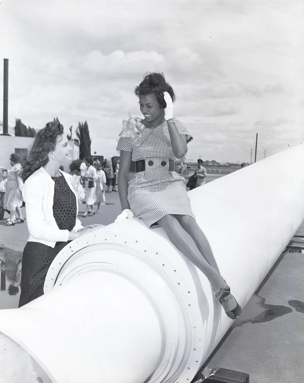 Woman Seated on Rocket Motor Casing Laughing with Companion, Public Open House Event, Early 1960s