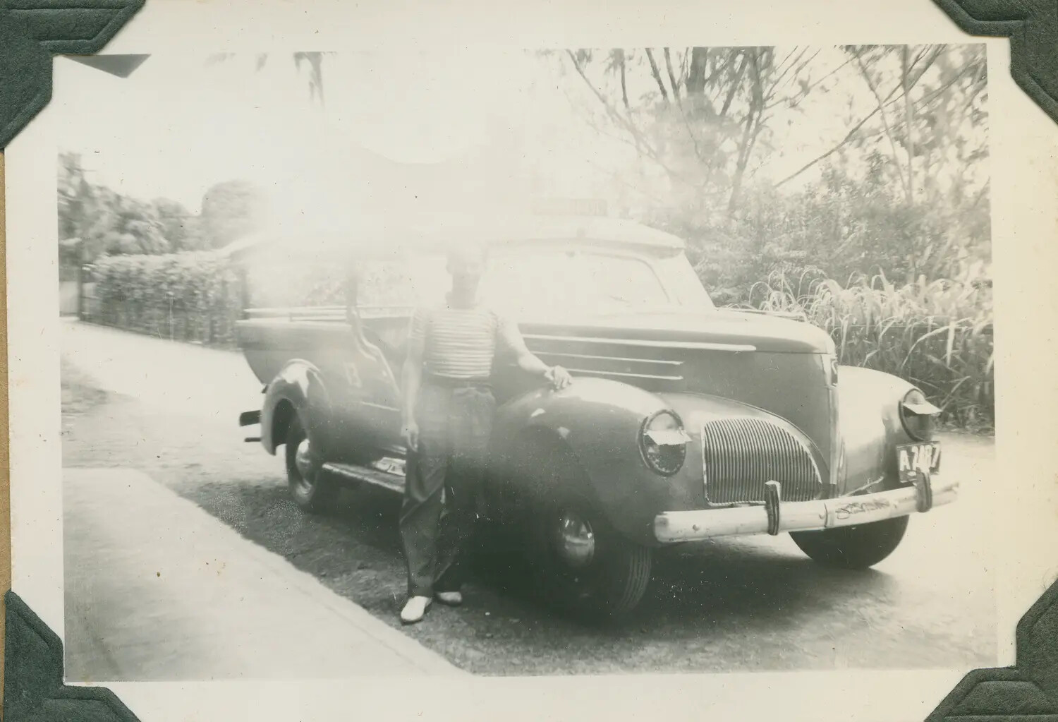 Man Posing with a Coupe-Utility Pickup Truck, Hawaii, c. 1943