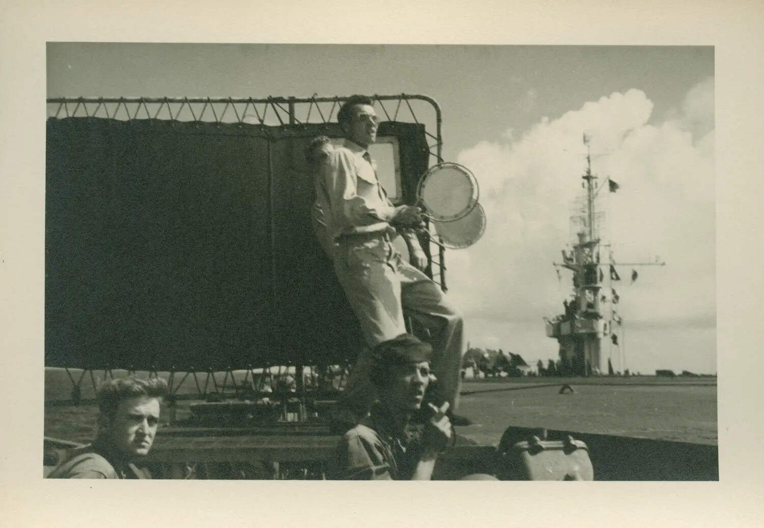Sailor Atop a Deck Vehicle with the Carrier's Island in the Background - USS Petrof Bay (CVE-80)