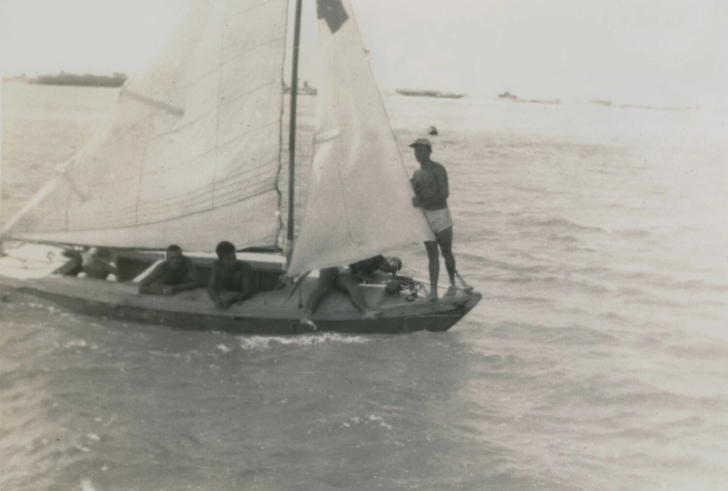 Servicemen Sailing a Small Sloop in Harbor, McAleer Photo Album