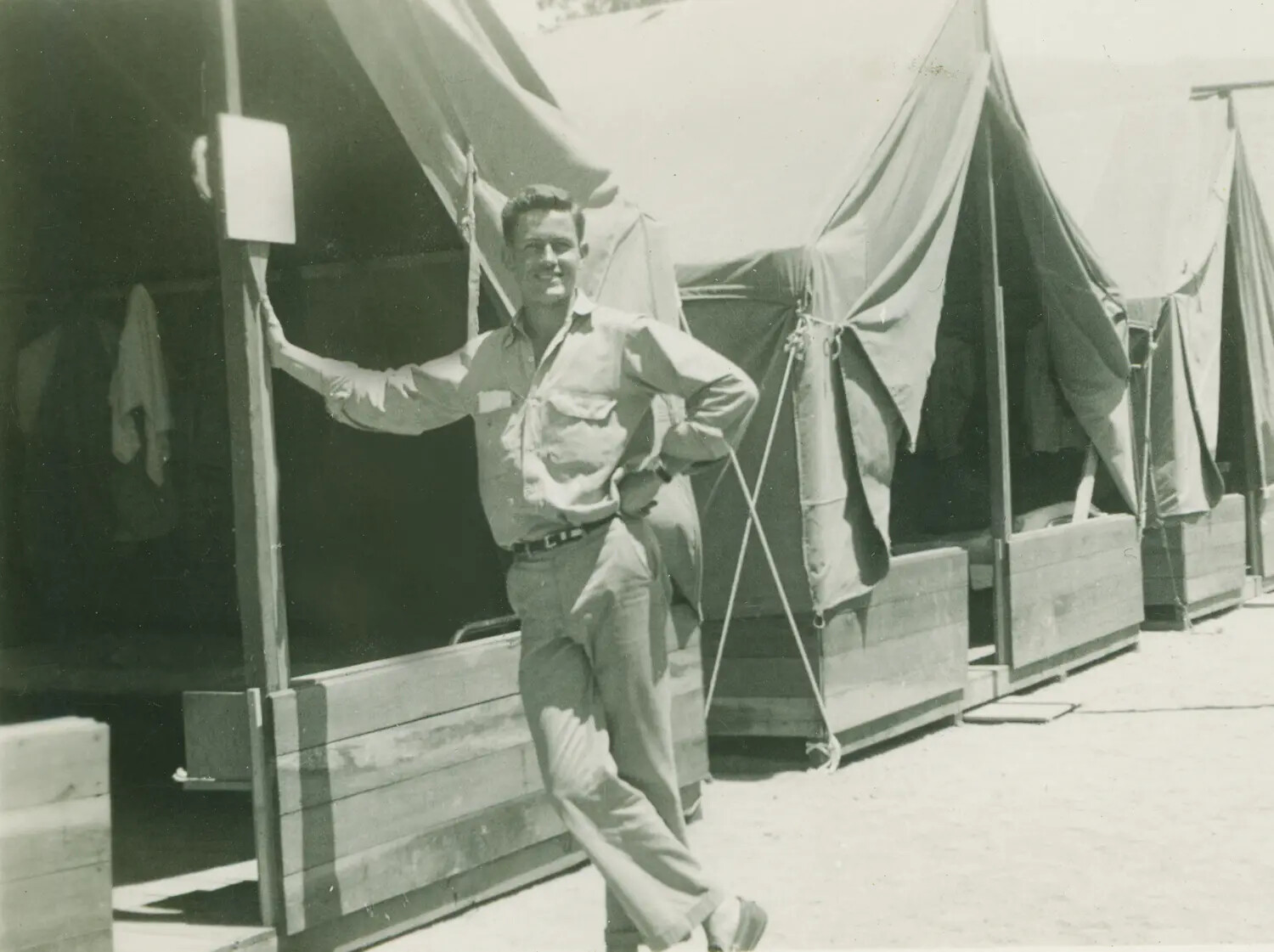 Serviceman Posing at a Tent-Camp Billet, WWII-era Base Camp