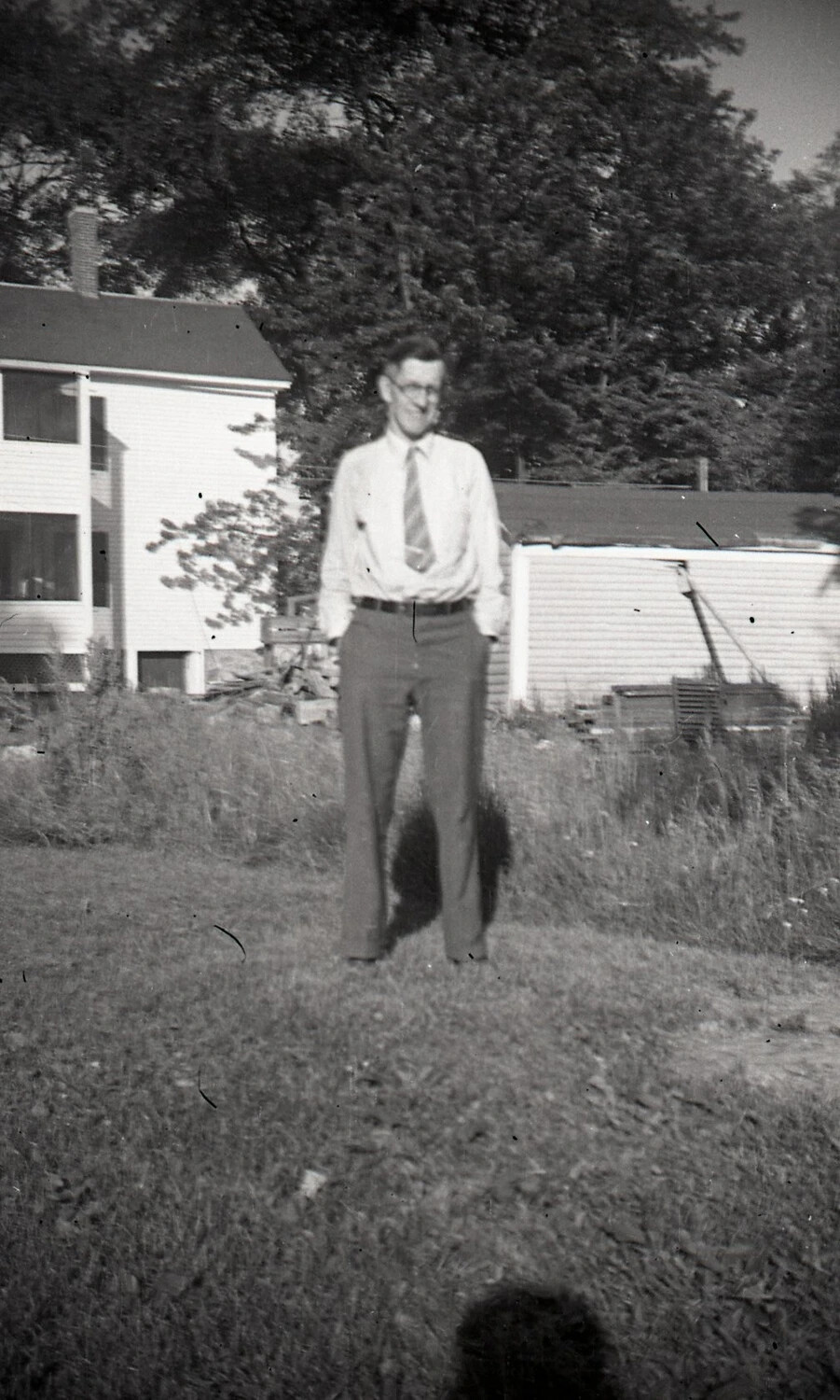 Man Standing in a Backyard Before a Clapboard House, c. 1940s
