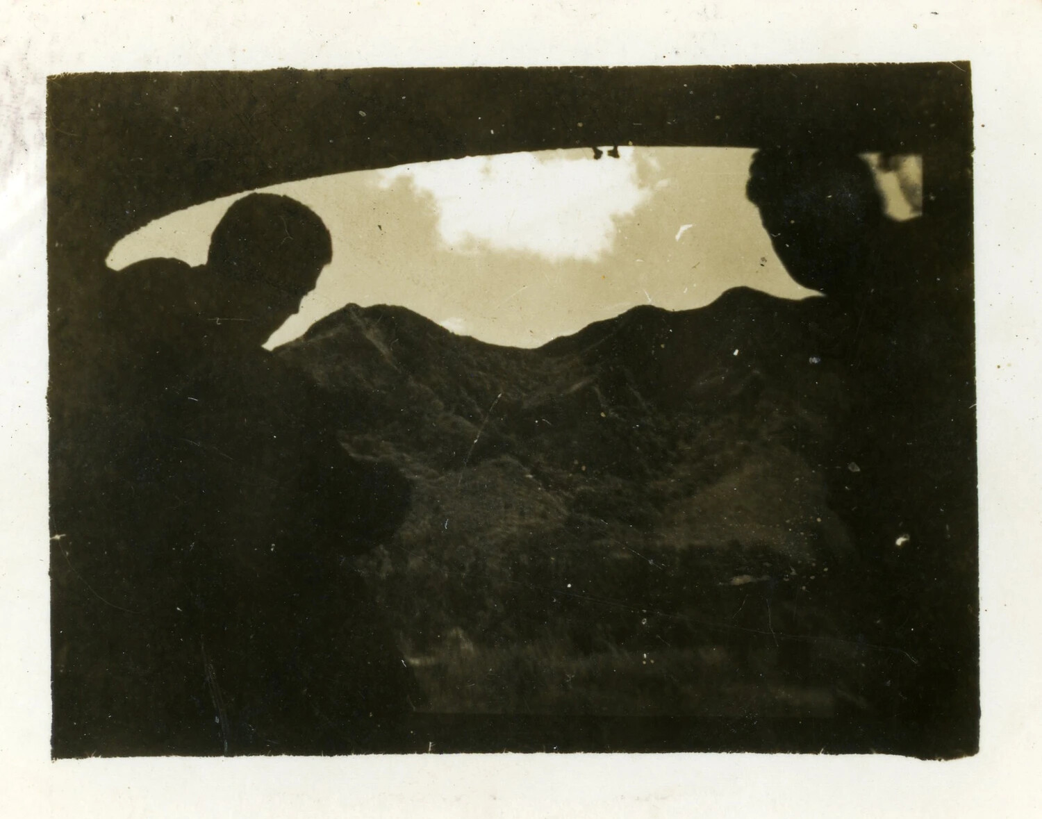 Silhouetted Figures Against Mountainous Terrain, World War II Era