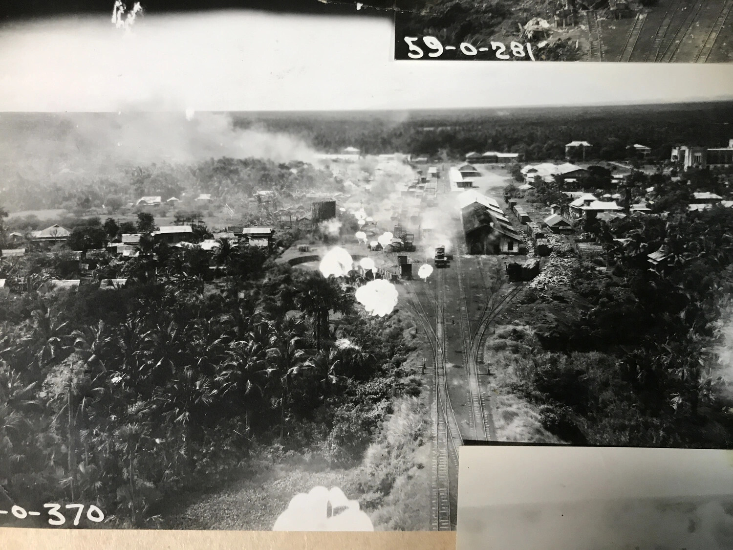 Railway Yard Under Bombardment with Multiple Bomb Bursts, Philippines - 312th Bomb Group Strike Photograph