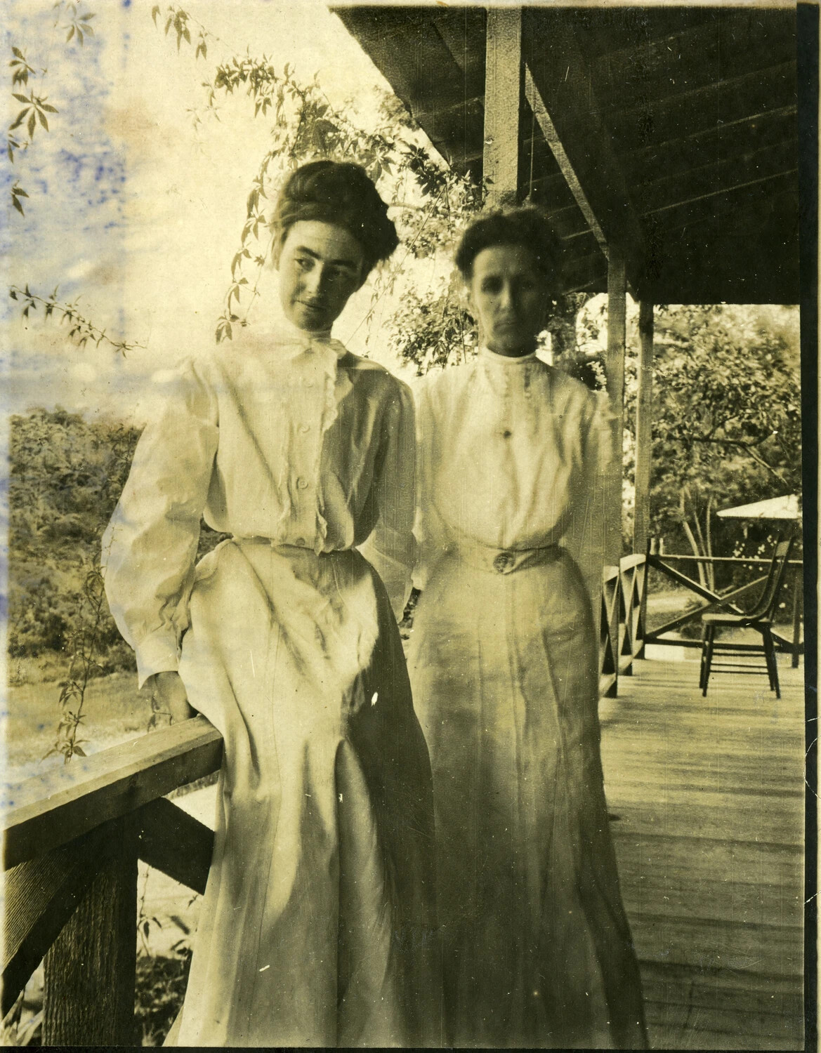 Two Women in Edwardian Dress on a Veranda, Philippines, Early 1900s (Stone Album)