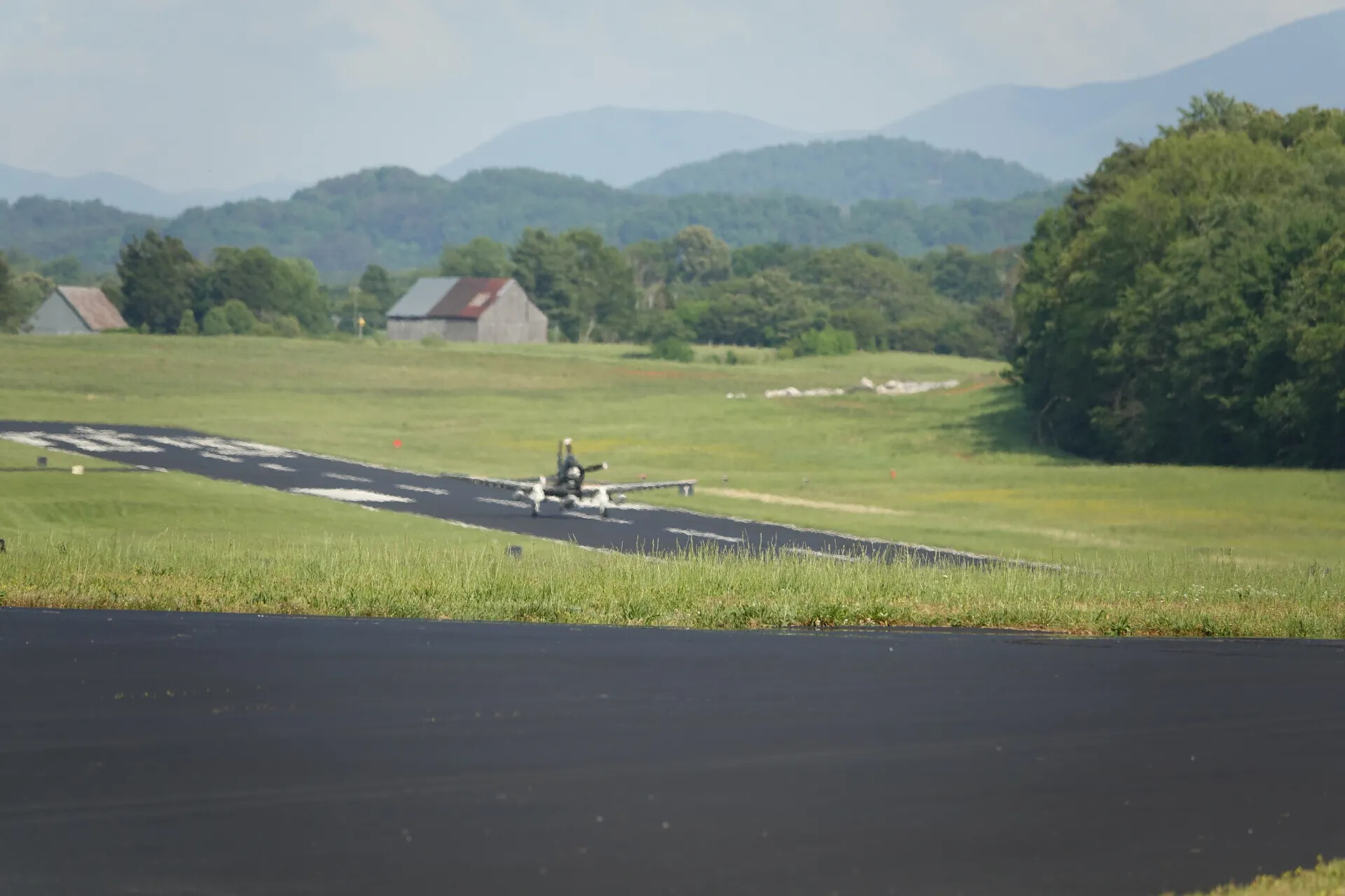 A-1 Skyraider Taxiing on Runway, Rural Mountain Airfield Backdrop