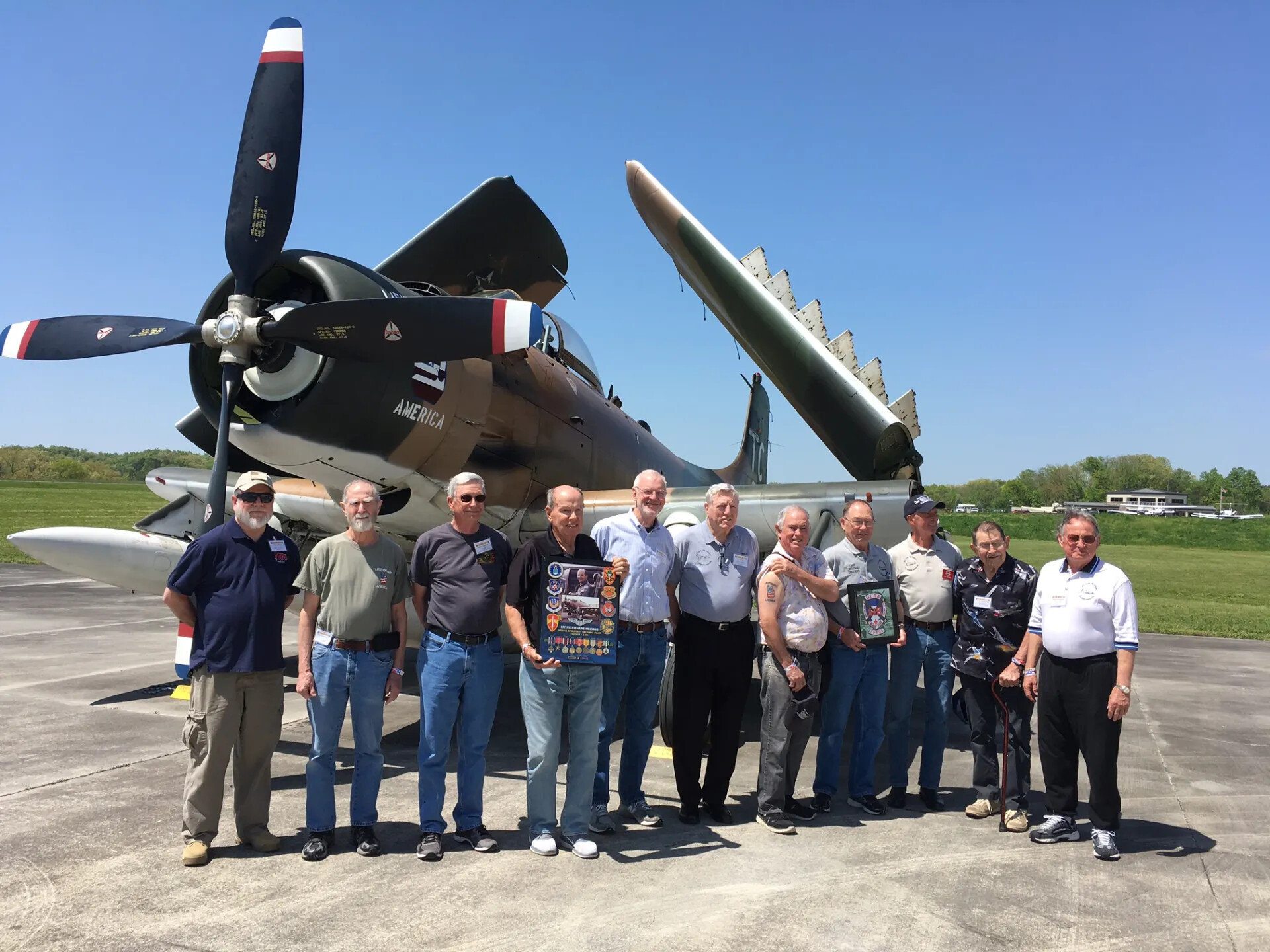 Group Portrait of Veteran Airmen with Restored A-1 Skyraider "America," Tailwind Day Reunion