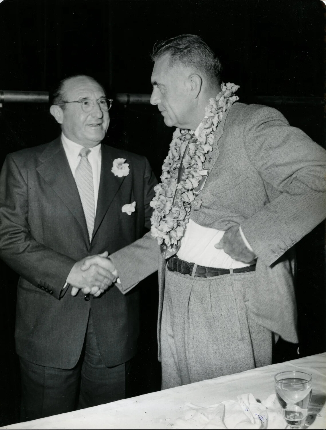 Guest of Honor in Ceremonial Lei Shakes Hands with Boutonniered Attendee, Late 1940s Convention