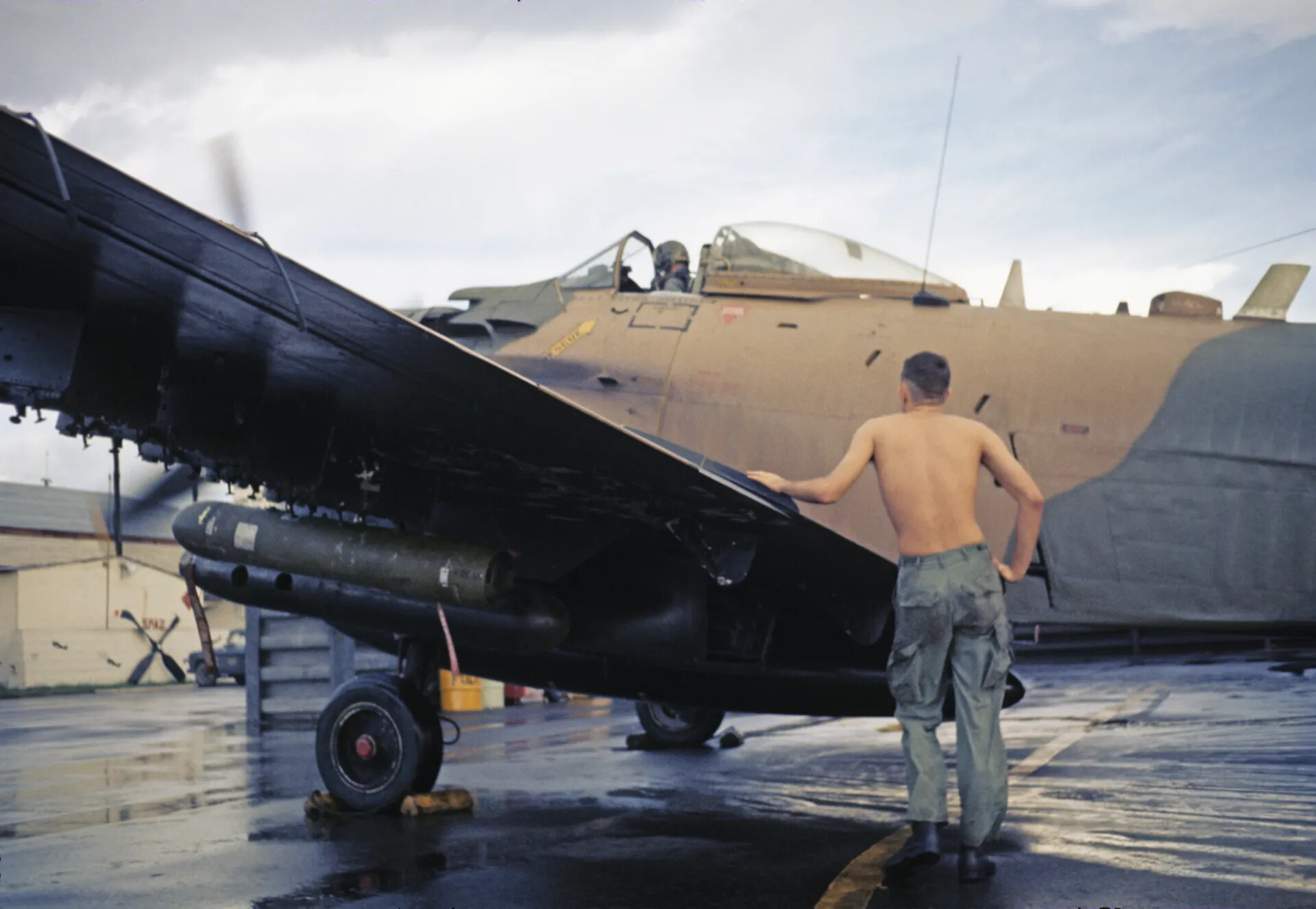 Ground Crewman and Pilot with A-1 Skyraider Beside 'SPAD' Squadron Building