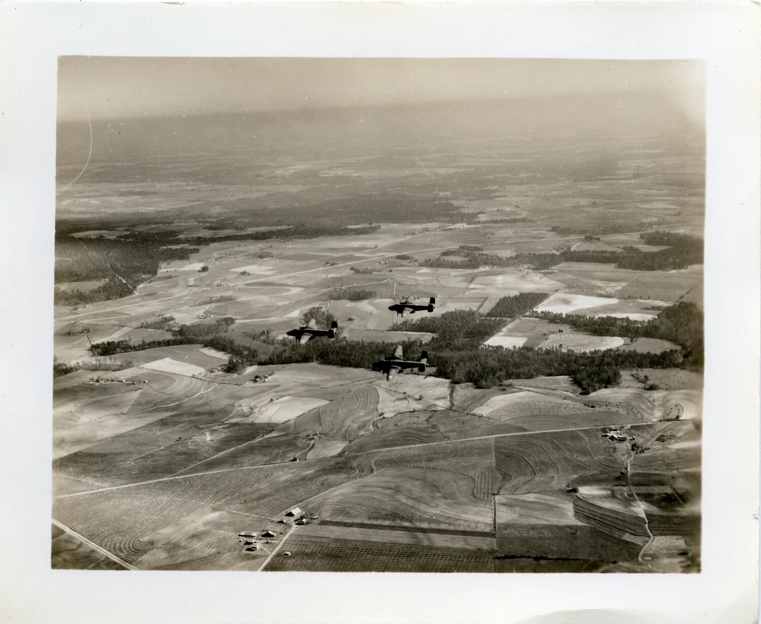 Three Medium Bombers in Formation Over Farmland (Filed as 'USO SHOW,' China-Burma-India Collection)
