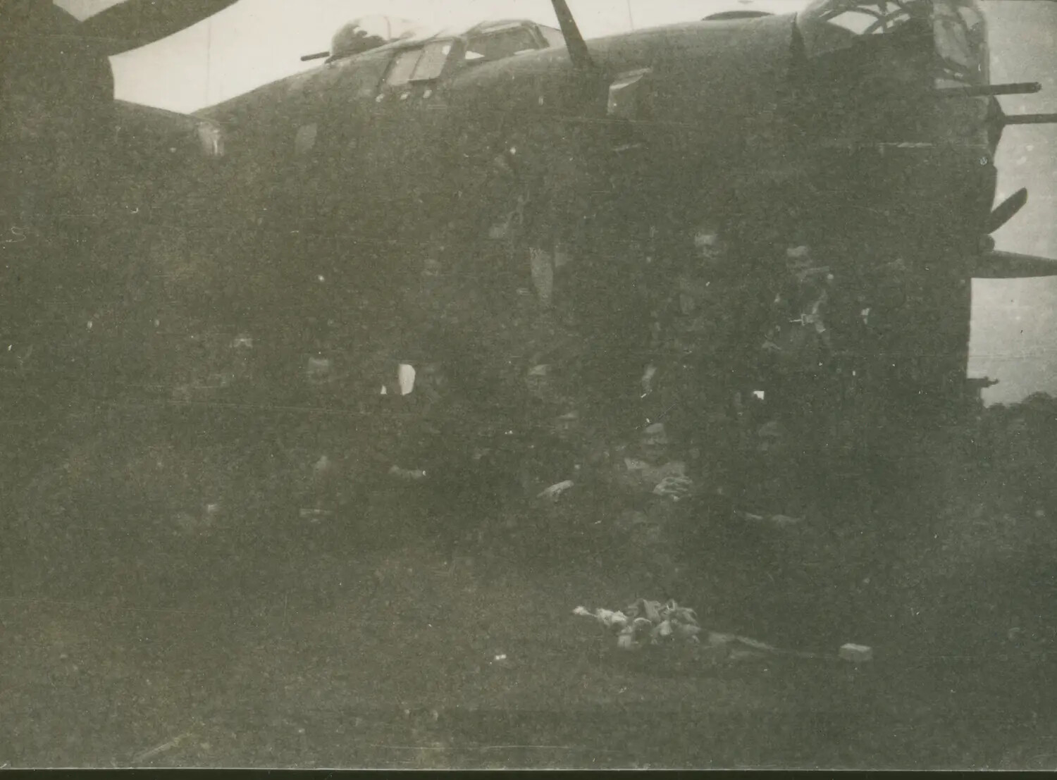 Bomber Crew Beneath Aircraft Nose Section, WWII, 579th Bomb Squadron (Underexposed)