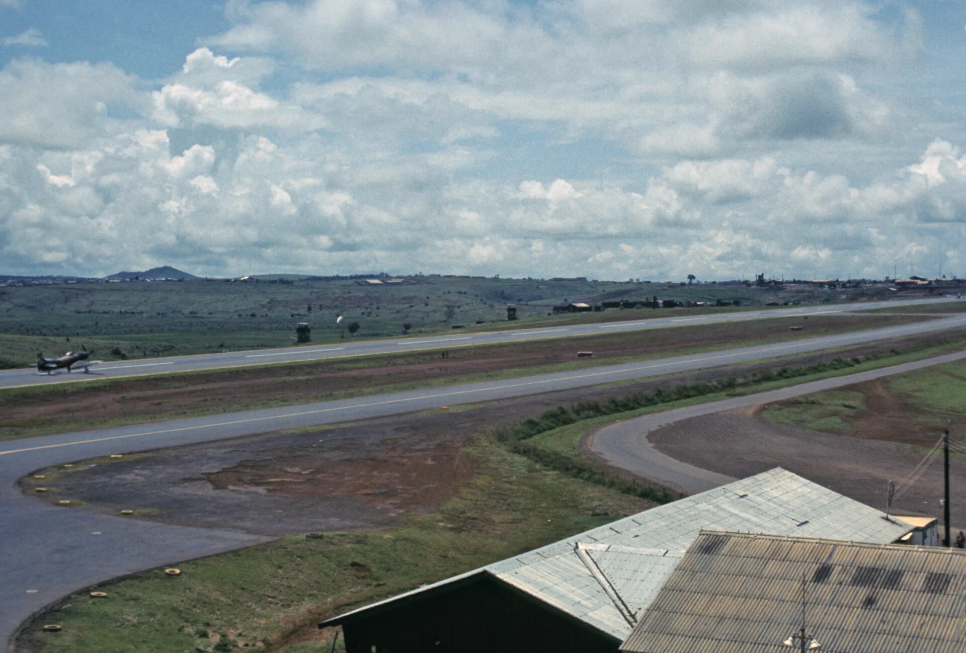 Elevated View Across a Southeast Asian Air Base Runway with a Skyraider on the Taxiway, circa October 1969