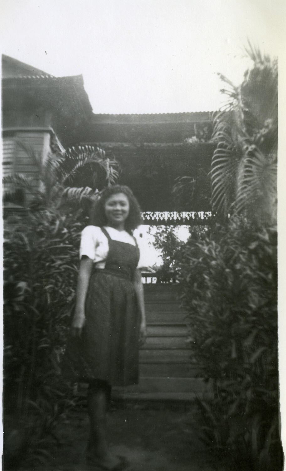 Young Woman Before a Traditional Wooden House, Pacific Theater, WWII Era