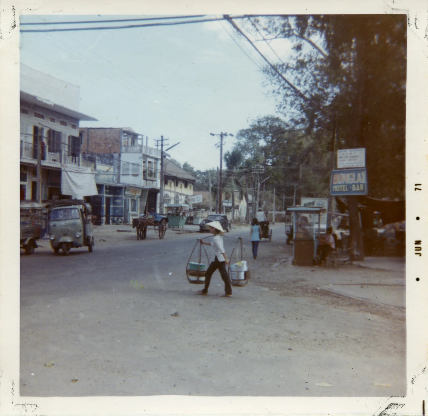 Vietnamese Town Street Scene with Pedestrian Carrying Shoulder Yoke, June 1971