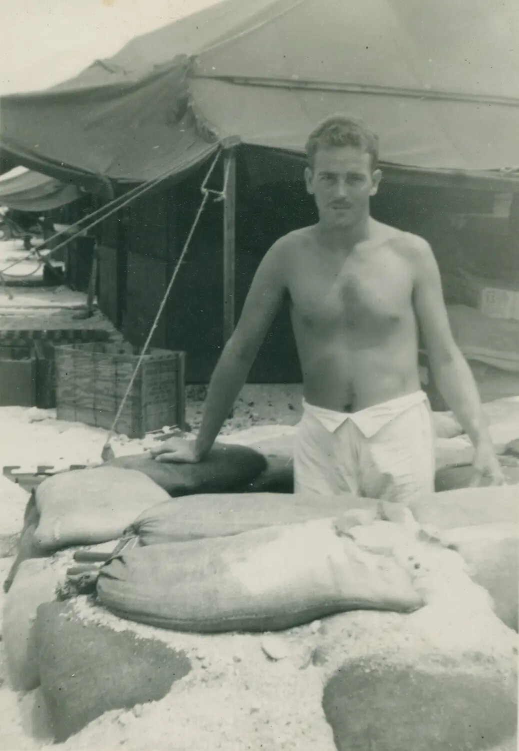 Serviceman Behind Sandbag Wall at Camp, Edward P. McAleer Album, WWII Era