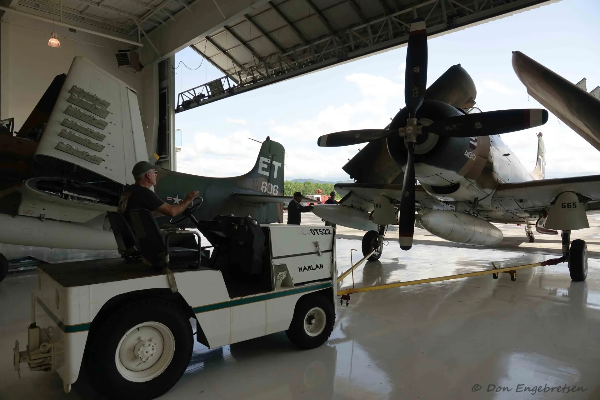 Douglas A-1 Skyraider Aircraft in Museum Hangar with Tow Tug and Visitor, May 2019
