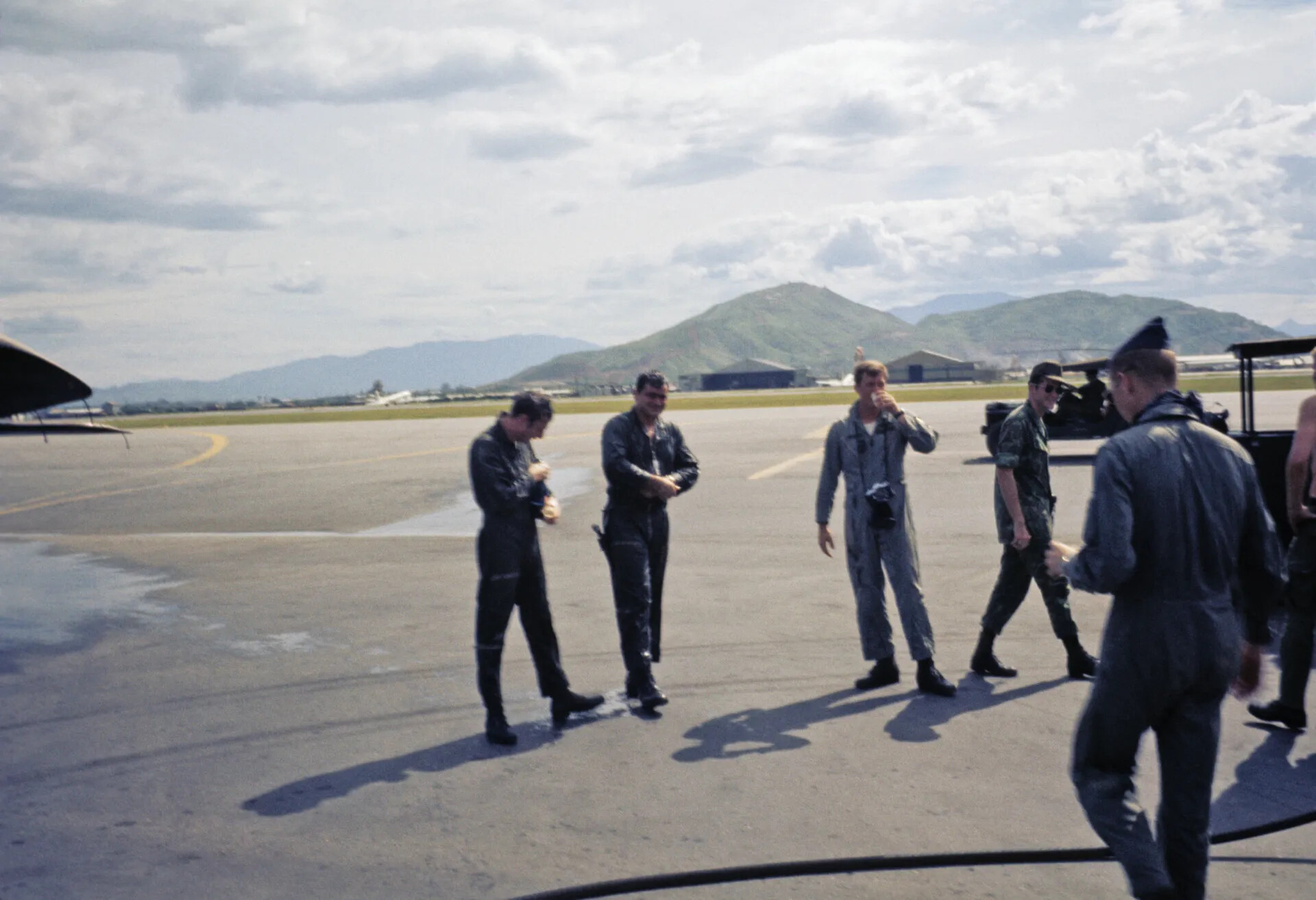 Aircrew Walking Across Wet Ramp After Fini-Flight Celebration, Vietnam War Era