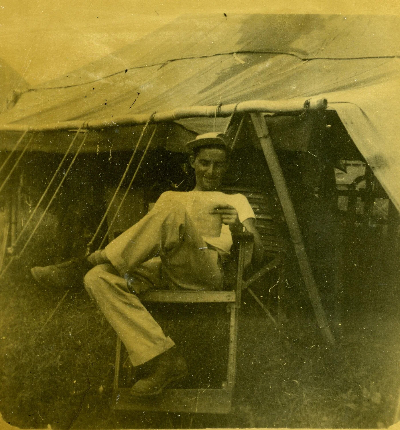 U.S. Airman Reading Mail in Squad Tent, 345th Bombardment Group Encampment, Pacific Theater, WWII