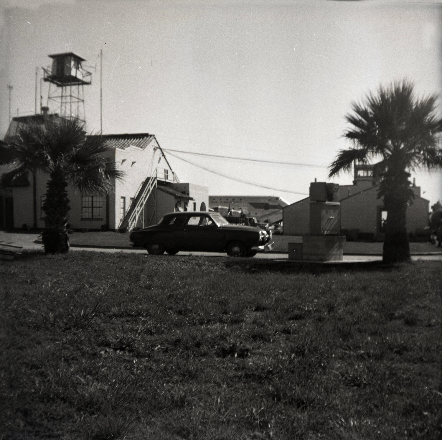 Spanish Colonial Revival Airfield Operations Building with Control Tower and Aircraft Tail