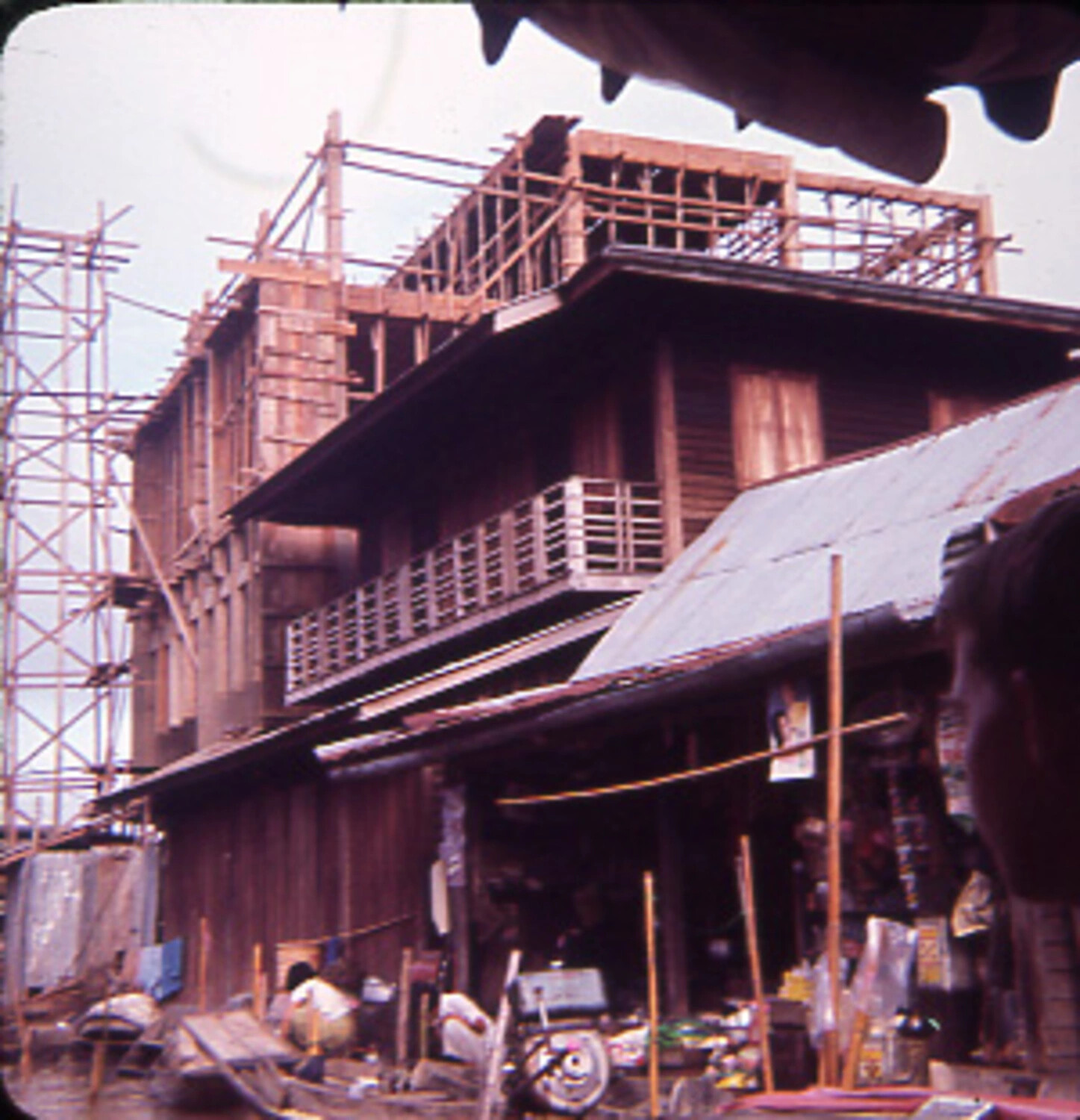 Wooden Shophouse Under Bamboo-Scaffolded Construction, Southeast Asian Market District