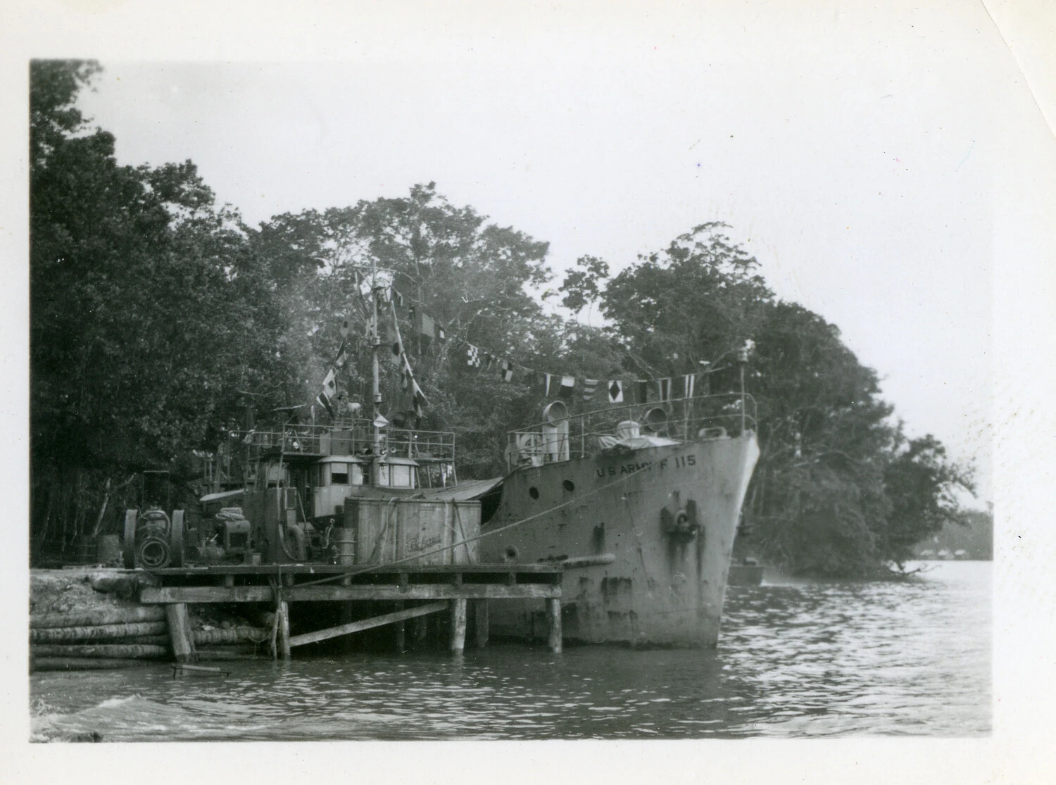 U.S. Army Freight and Supply Vessel F-115 Moored and Dressed with Signal Flags, Pacific Theater, WWII