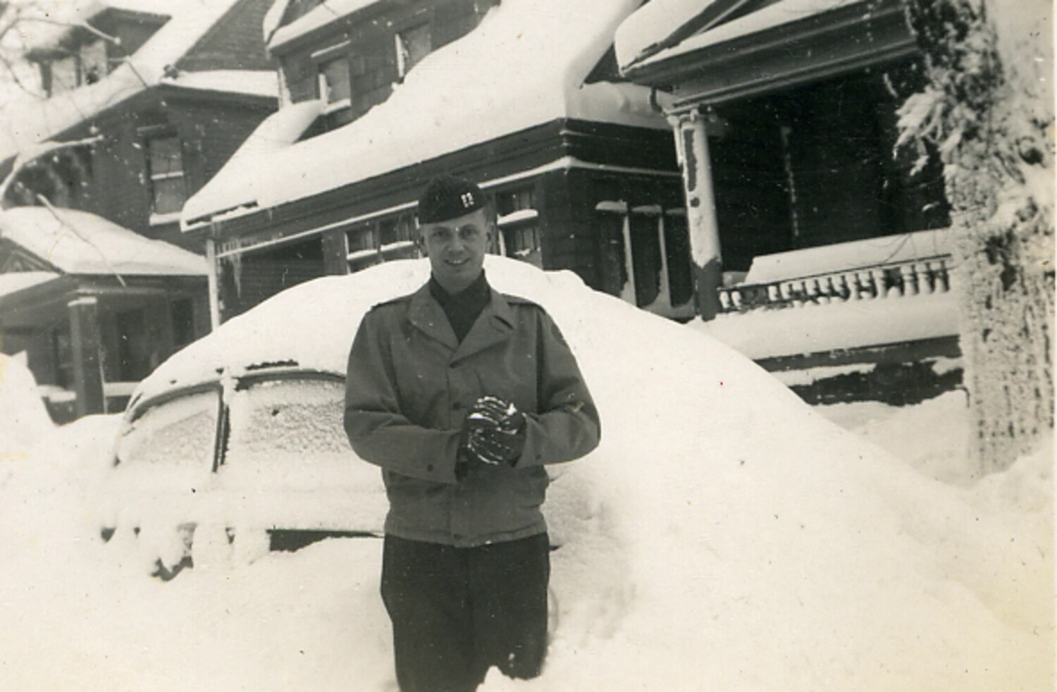 Serviceman in Snowstorm Beside Snow-Covered Automobile, United States, Late 1940s-1950s