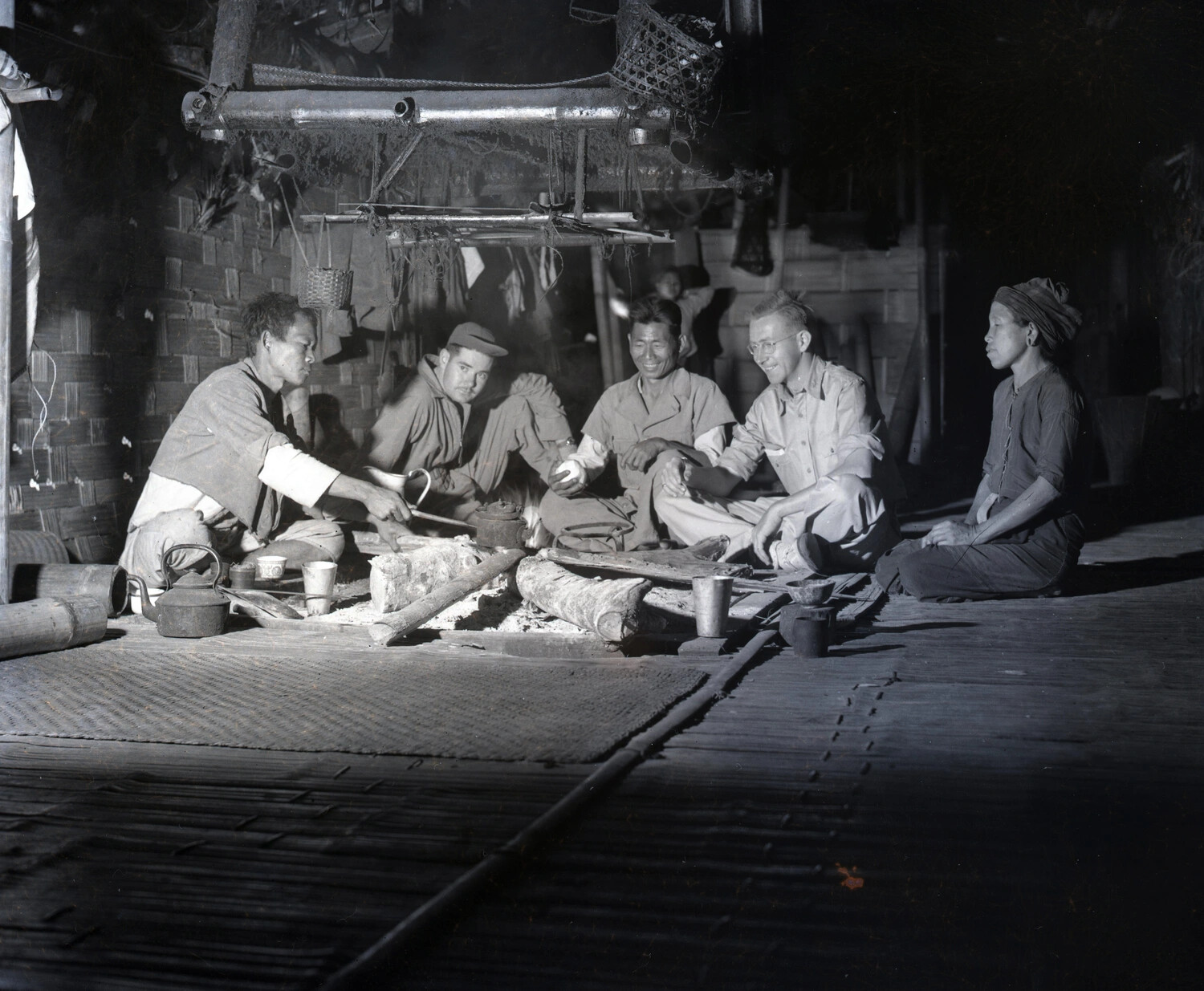 American Servicemen Sharing a Meal with Local Villagers in a Bamboo Hut, Burma, WWII