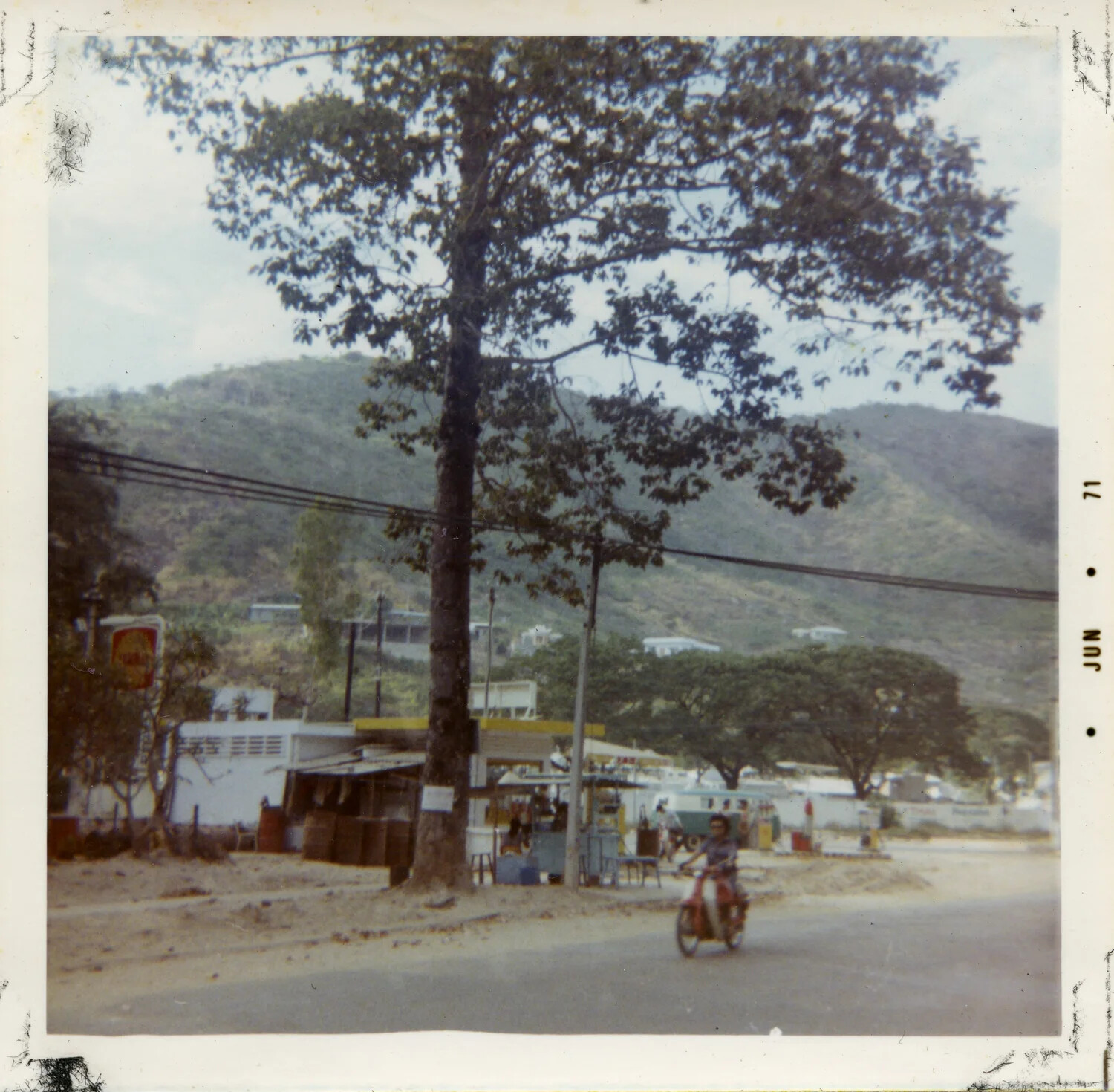 Roadside Scene with Motorbike and Hillside Fuel Stand, Vietnam, 1971