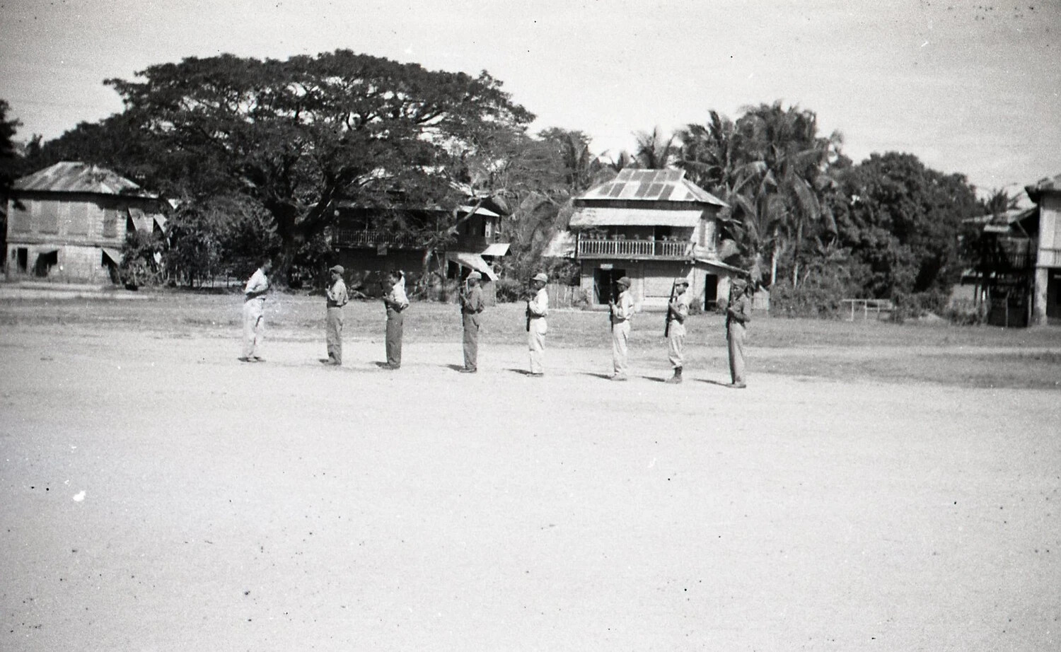 Soldiers in Formation Before Village Houses, Luzon, Philippines, WWII Era