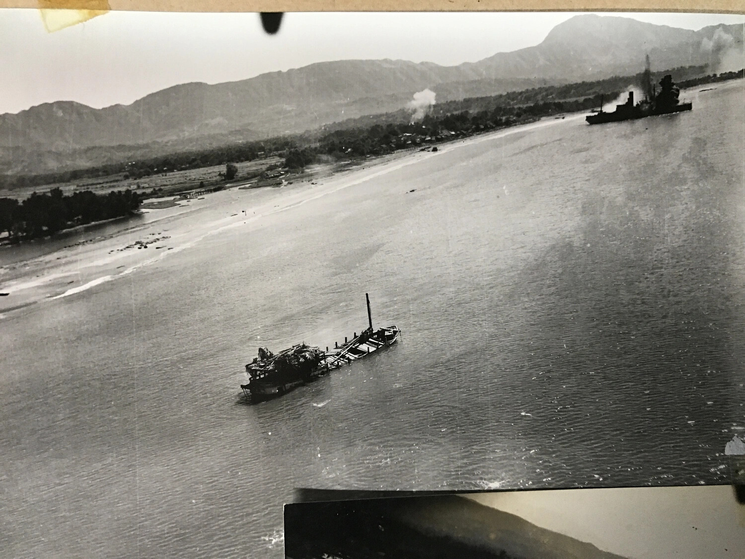 Aerial Photograph: Sunken and Burning Vessels in Coastal Bay, Pacific Theater, WWII