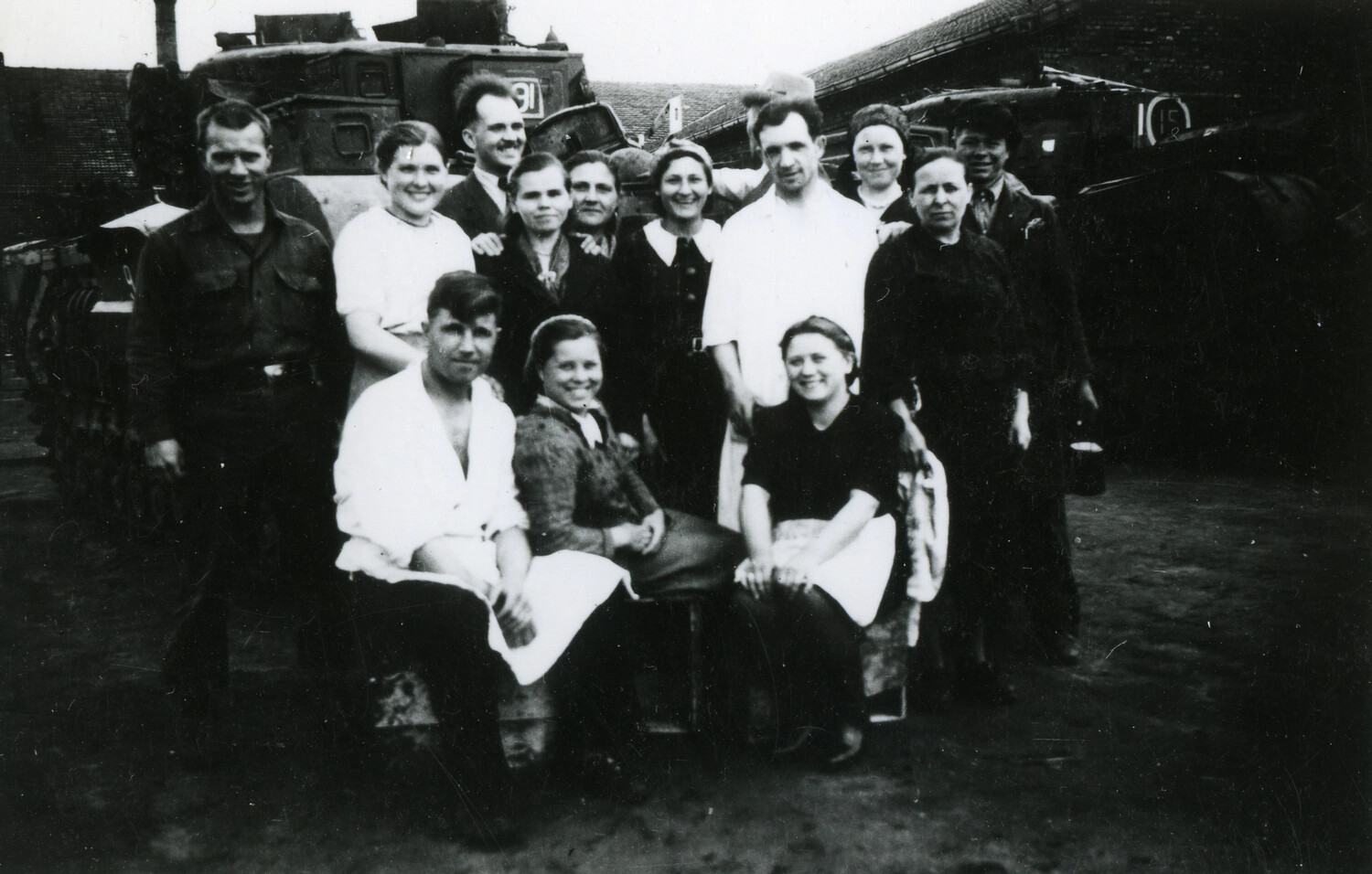 American Soldier and European Civilians Pose Before a Damaged Armored Vehicle, 101st Airborne Collection